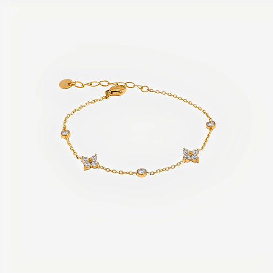 Gold bracelet with small diamonds on a light beige background