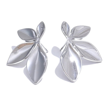 Pair of silver leaf-shaped earrings on a white background