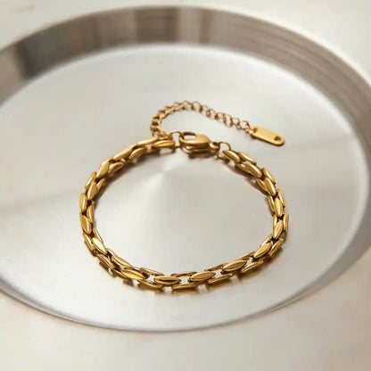 Gold bracelet on a silver tray