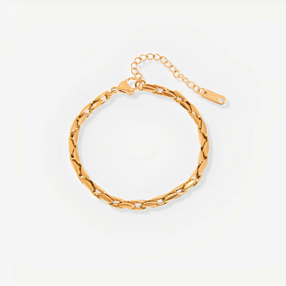 Gold chain bracelet on a light beige background