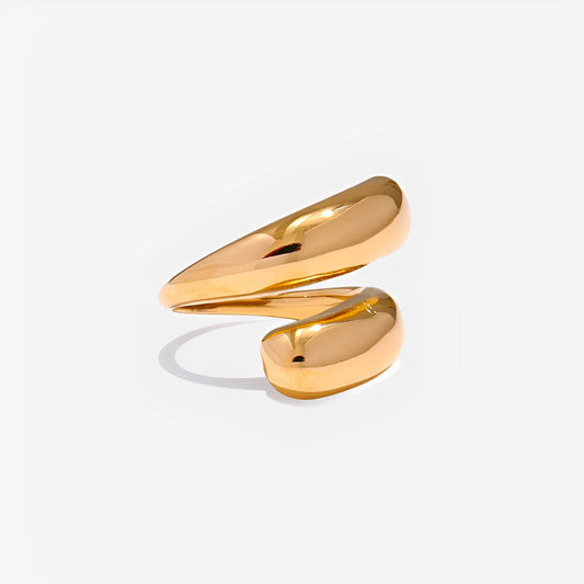 Gold ring with a wavy design on a light gray background
