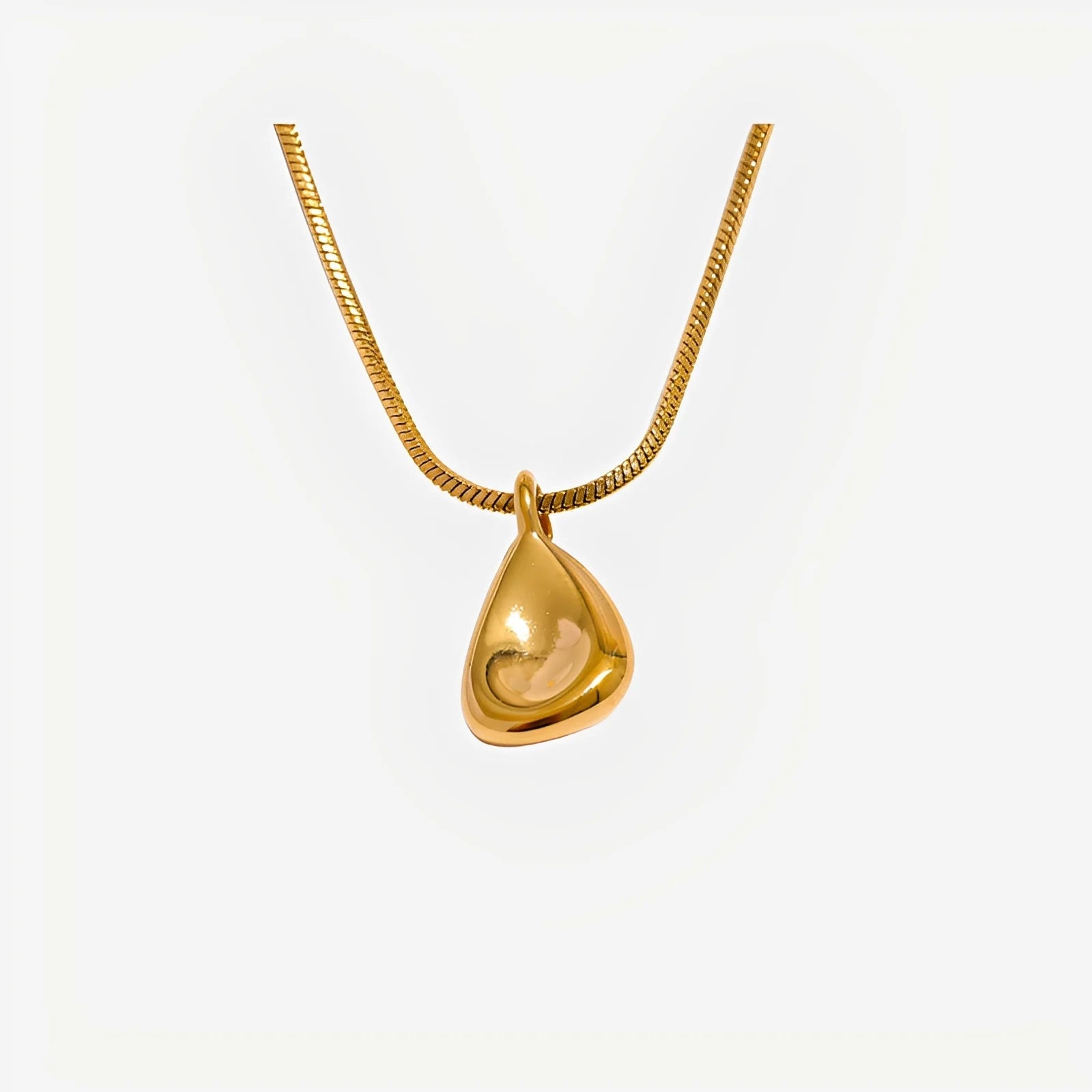 Gold teardrop pendant necklace on a white background