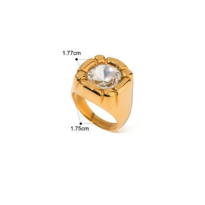 Gold ring with a large central gemstone on a white background