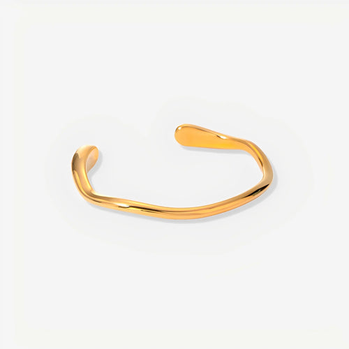 Gold bangle on a light gray background