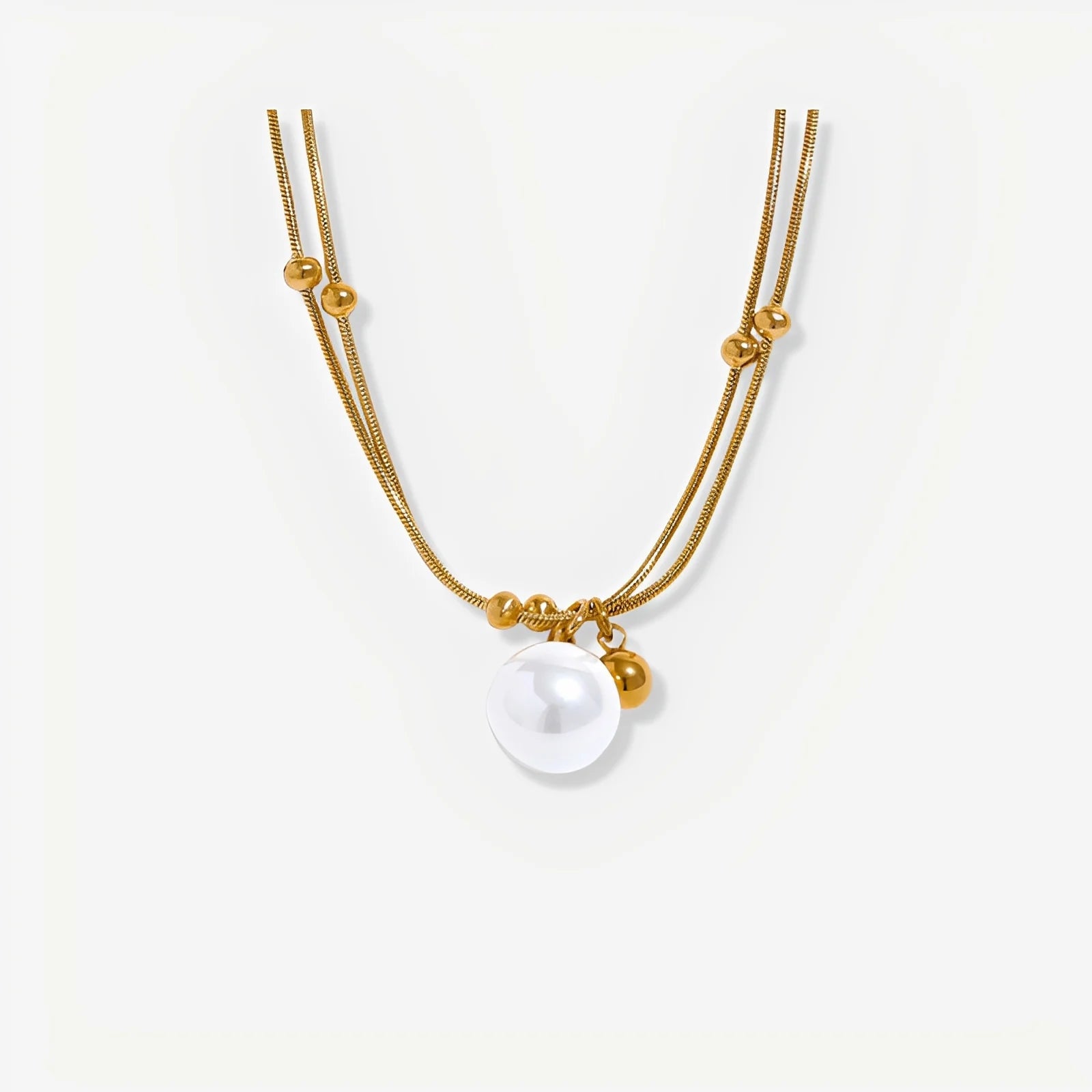 Gold necklace with a pearl pendant on a white background