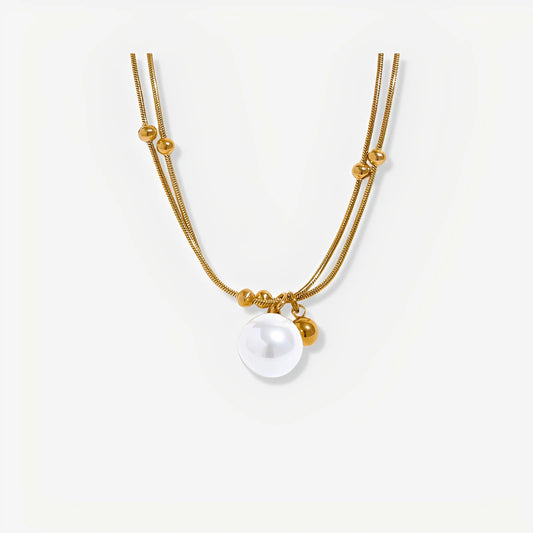 Gold necklace with a pearl pendant on a white background