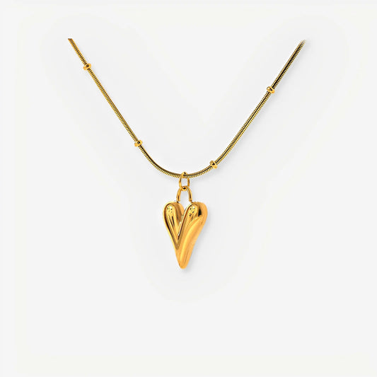 Gold heart-shaped pendant necklace on a white background