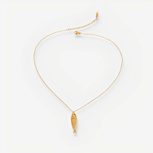 Gold necklace with a fish pendant on a white background