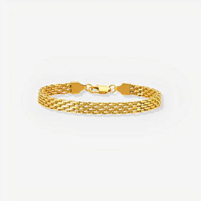 Gold bracelet on a light gray background