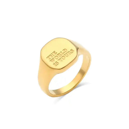 Gold ring with 'The World is Yours' engraving on a white background