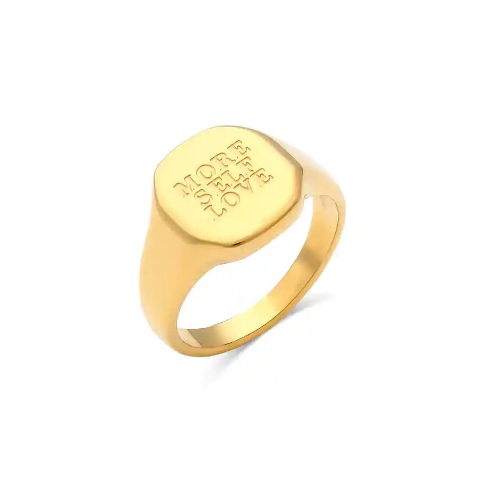 Gold ring with engraved text on a white background