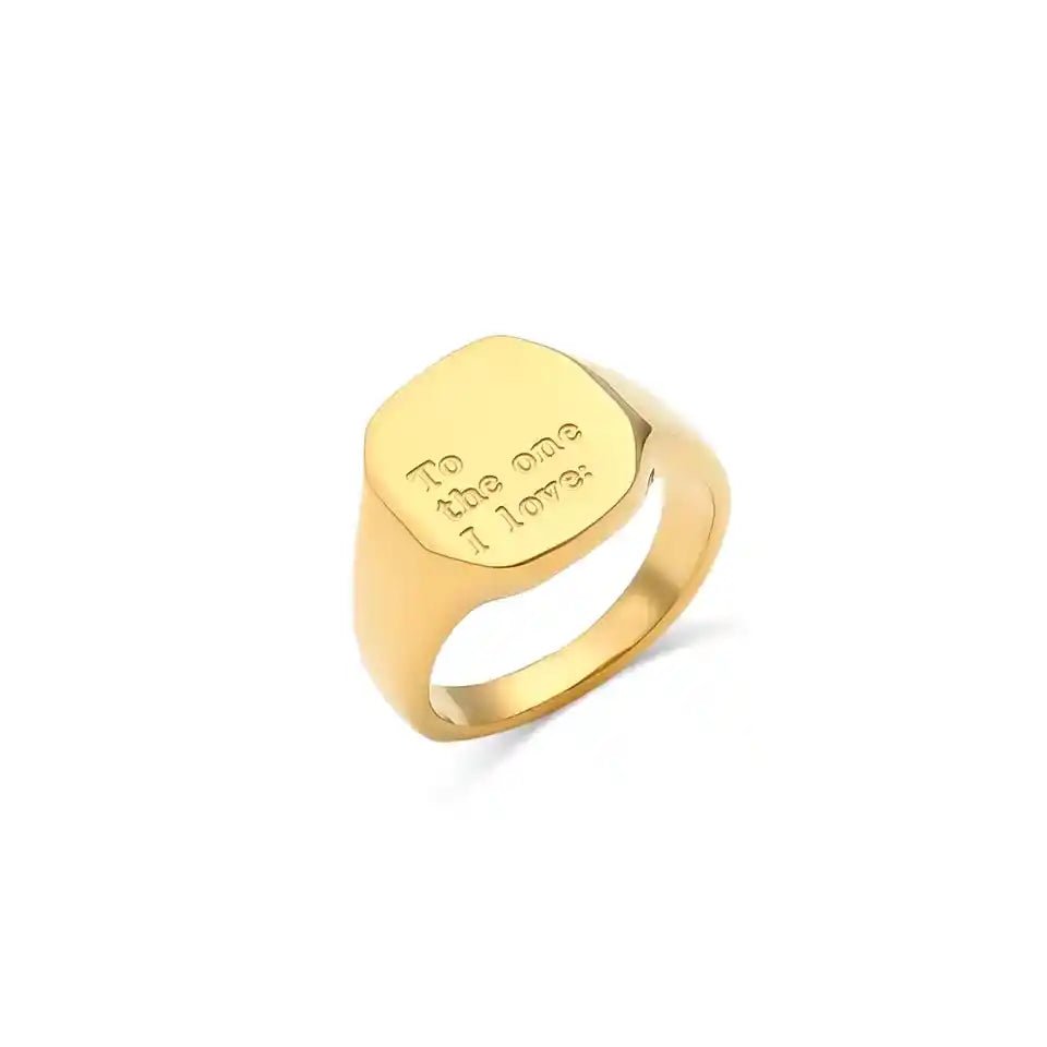 Gold ring with engraved text on a white background