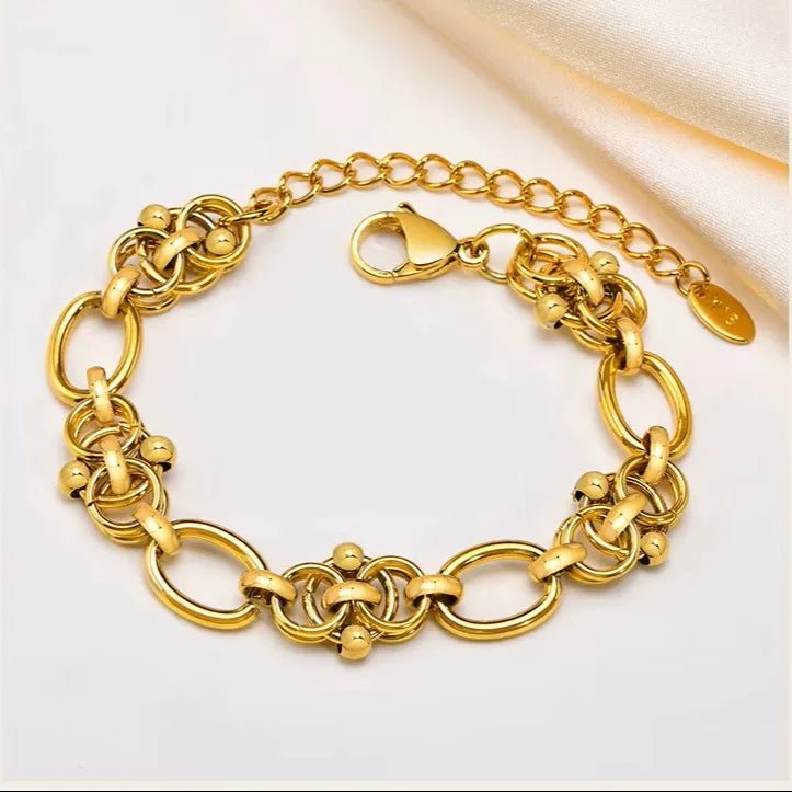 Gold chain bracelet on a light background