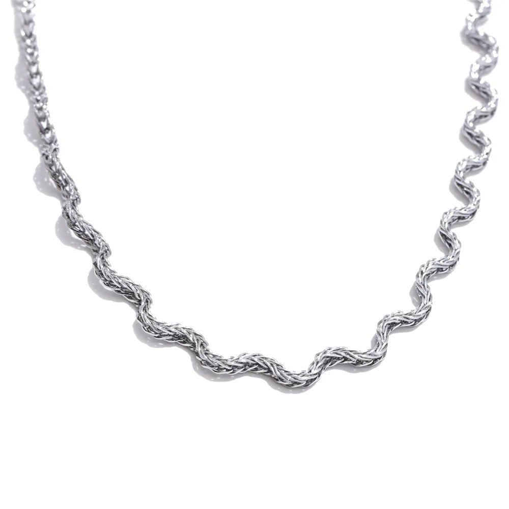 Silver rope chain necklace on a white background