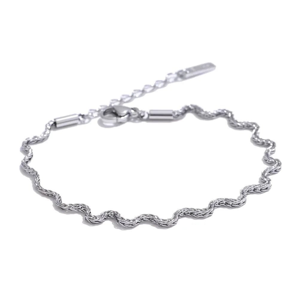 Silver bracelet with a rope design on a white background