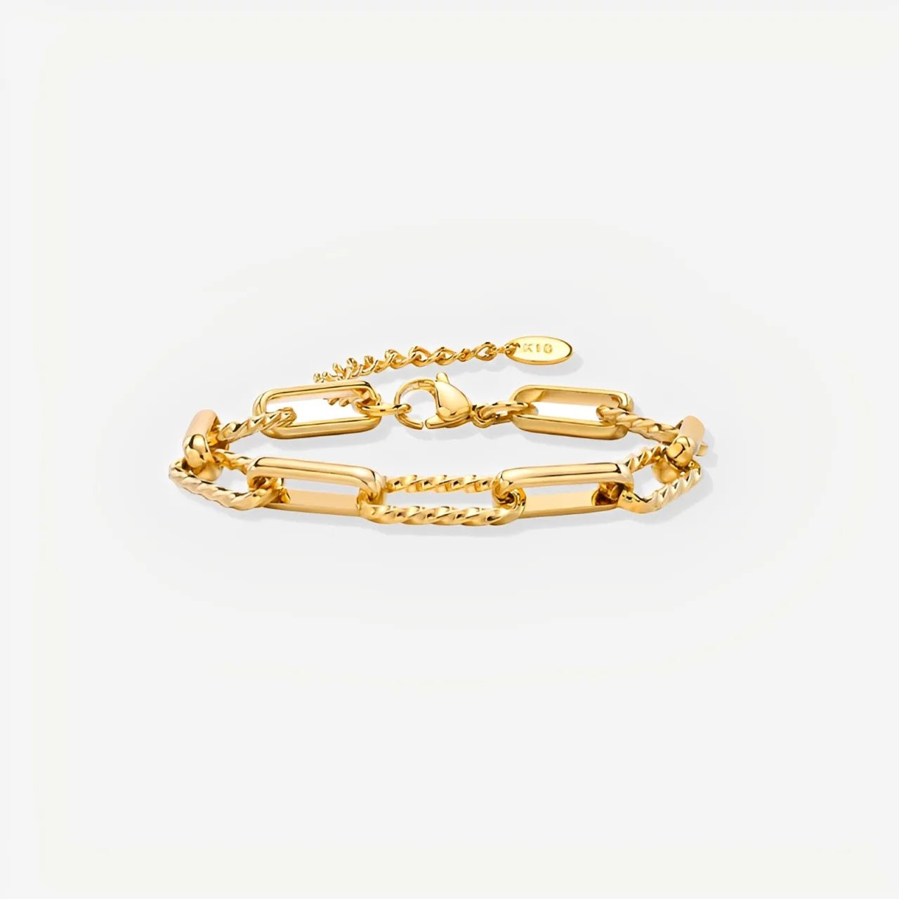 Gold chain bracelet on a light gray background