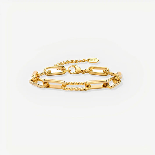 Gold chain bracelet on a light gray background