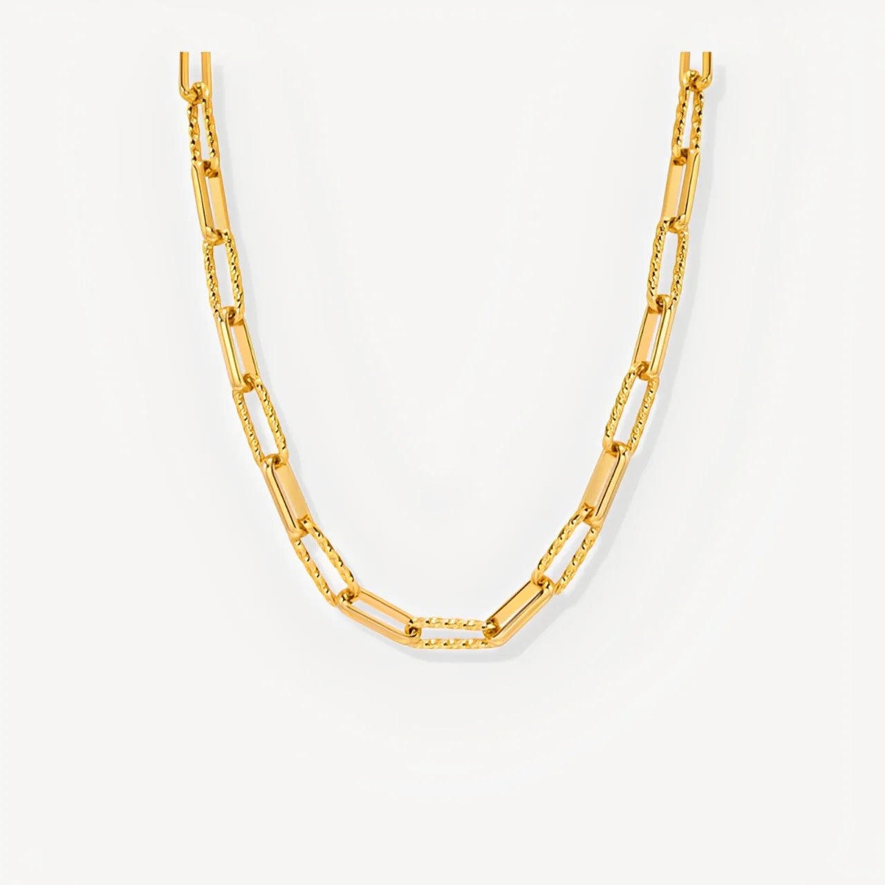 Gold chain necklace on a white background