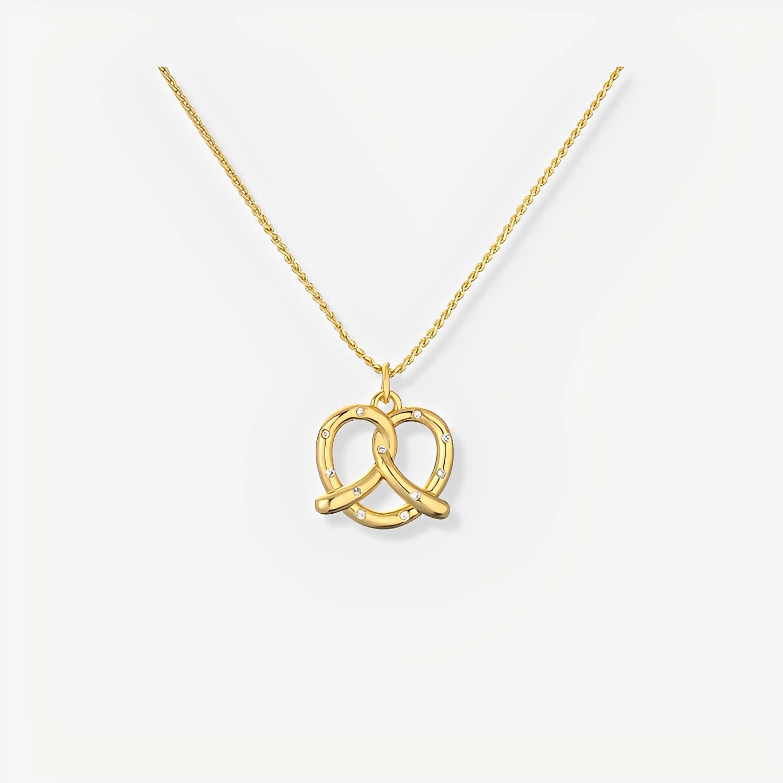 Gold necklace with a double interlocking ring pendant on a white background