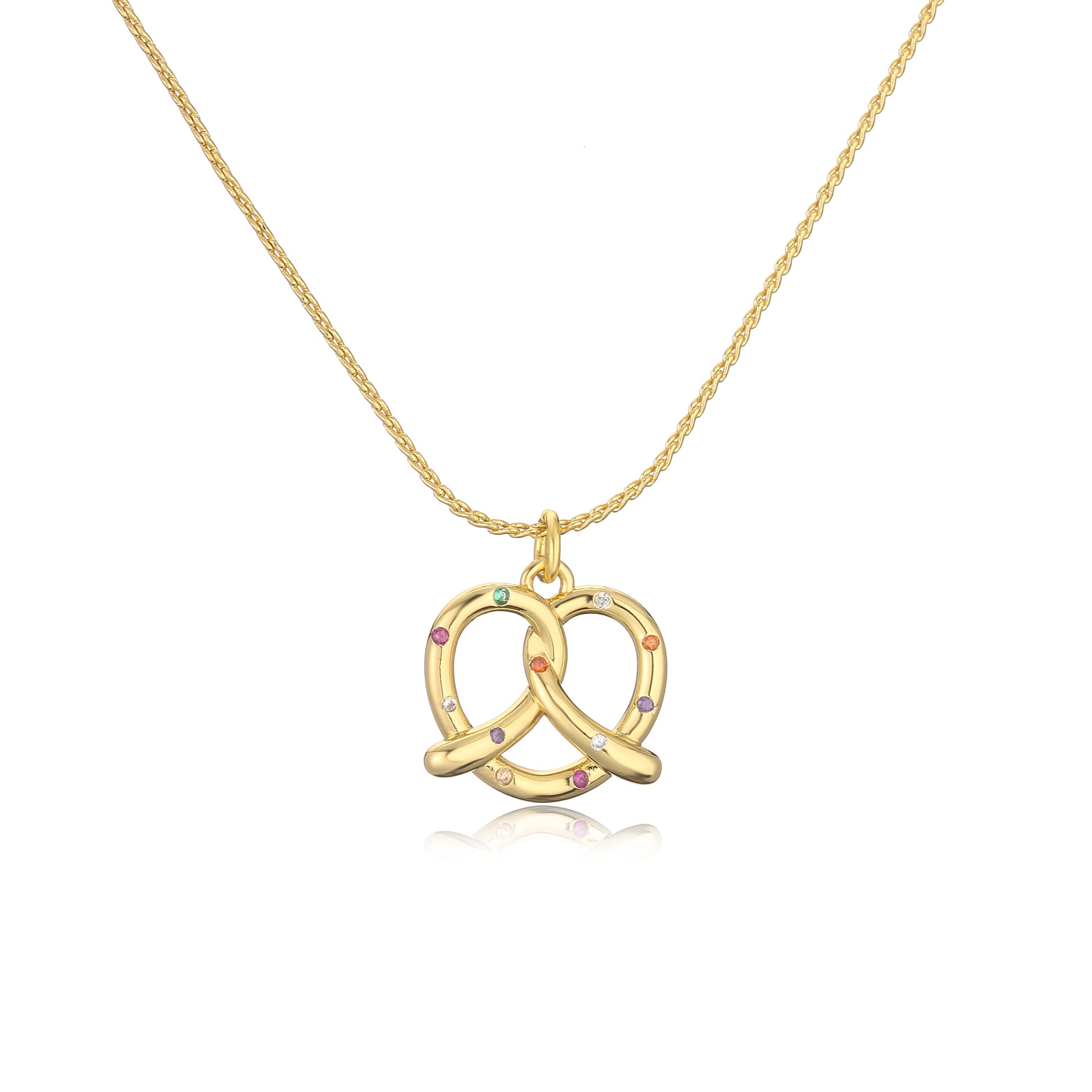 Gold pretzel-shaped pendant necklace with colorful stones on a white background