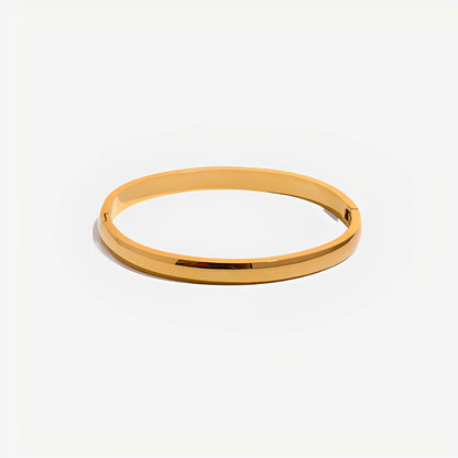 Gold bangle on a white background