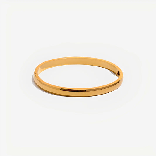 Gold bangle on a white background