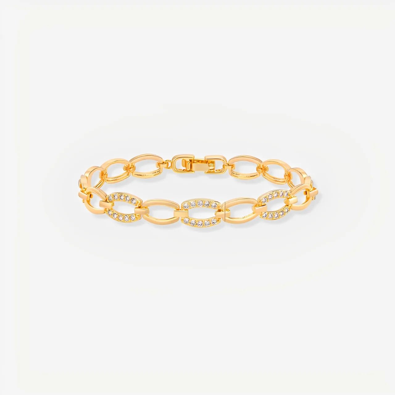 Gold chain bracelet on a light gray background