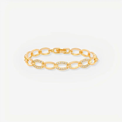 Gold chain bracelet on a light gray background