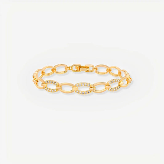 Gold chain bracelet on a light gray background