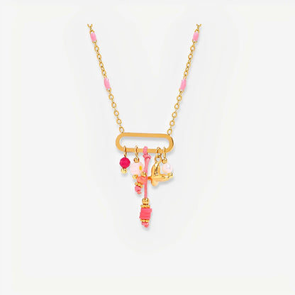 Gold necklace with pink beads and charms on a white background