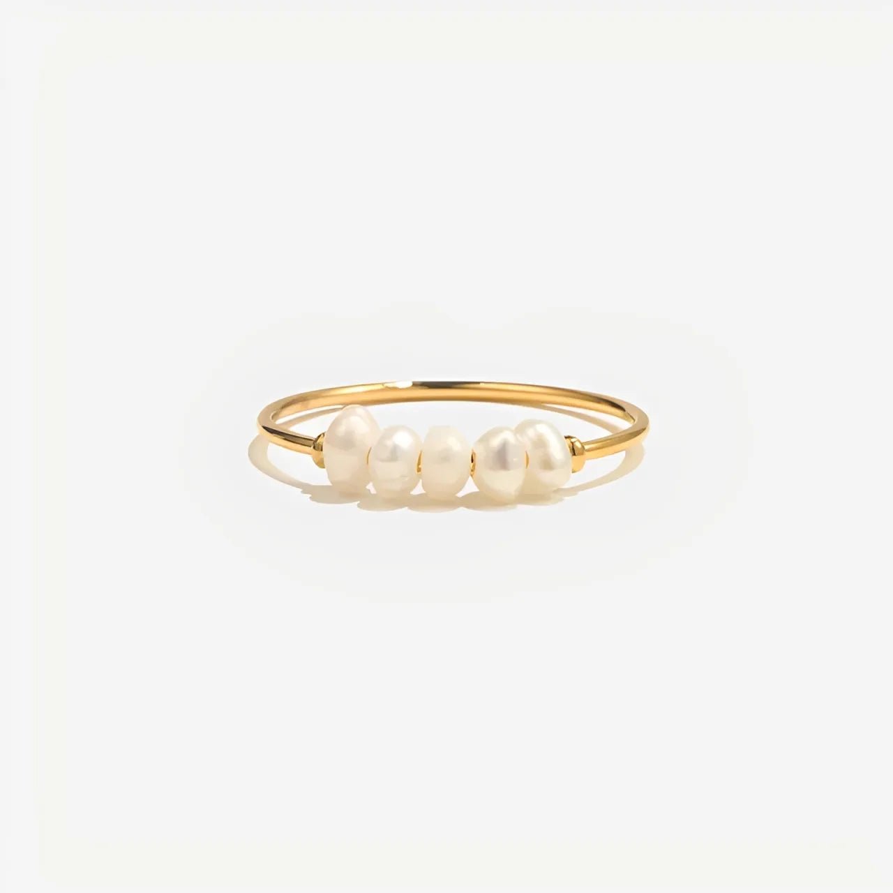 Gold ring with pearls on a white background