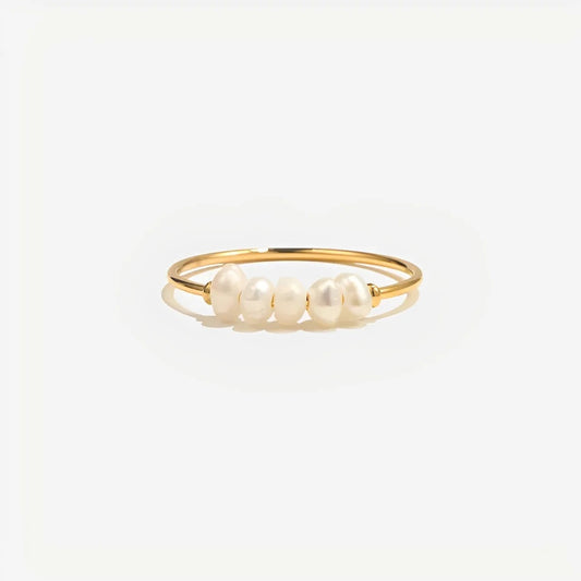 Gold ring with pearls on a white background