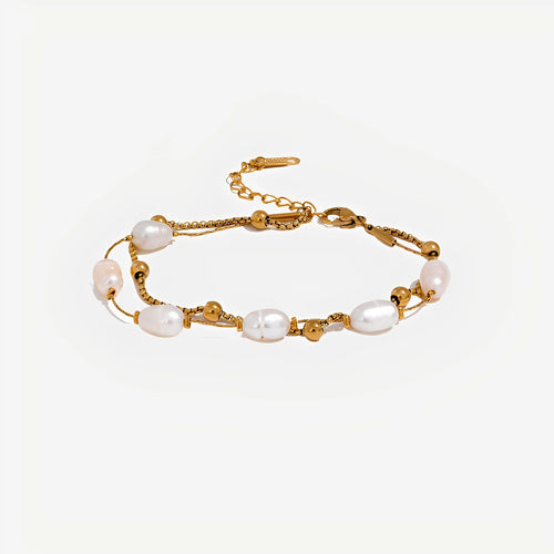 Gold bracelet with pearls on a white background