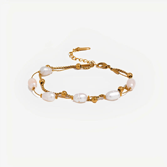 Gold bracelet with pearls on a white background