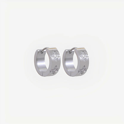Silver hoop earrings with small round stones on a light gray background