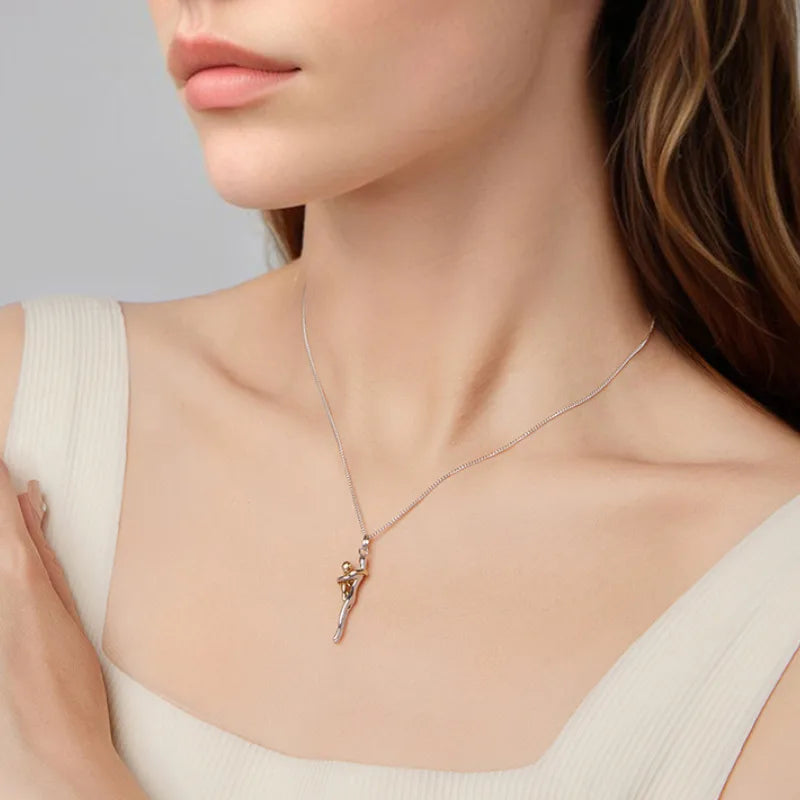 Necklace with a pendant worn by a person against a neutral background