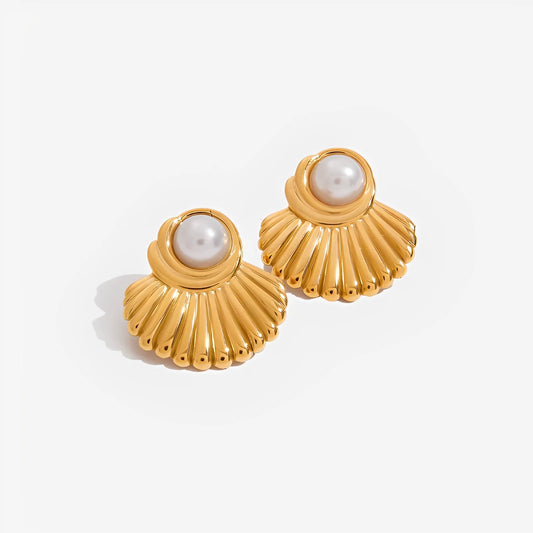 Gold shell-shaped earrings with pearl centers on a white background