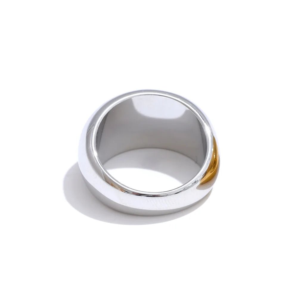Silver ring with gold accent on a white background