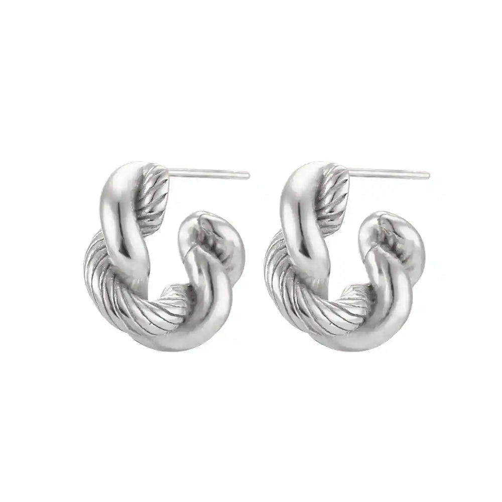 Pair of silver hoop earrings on a white background