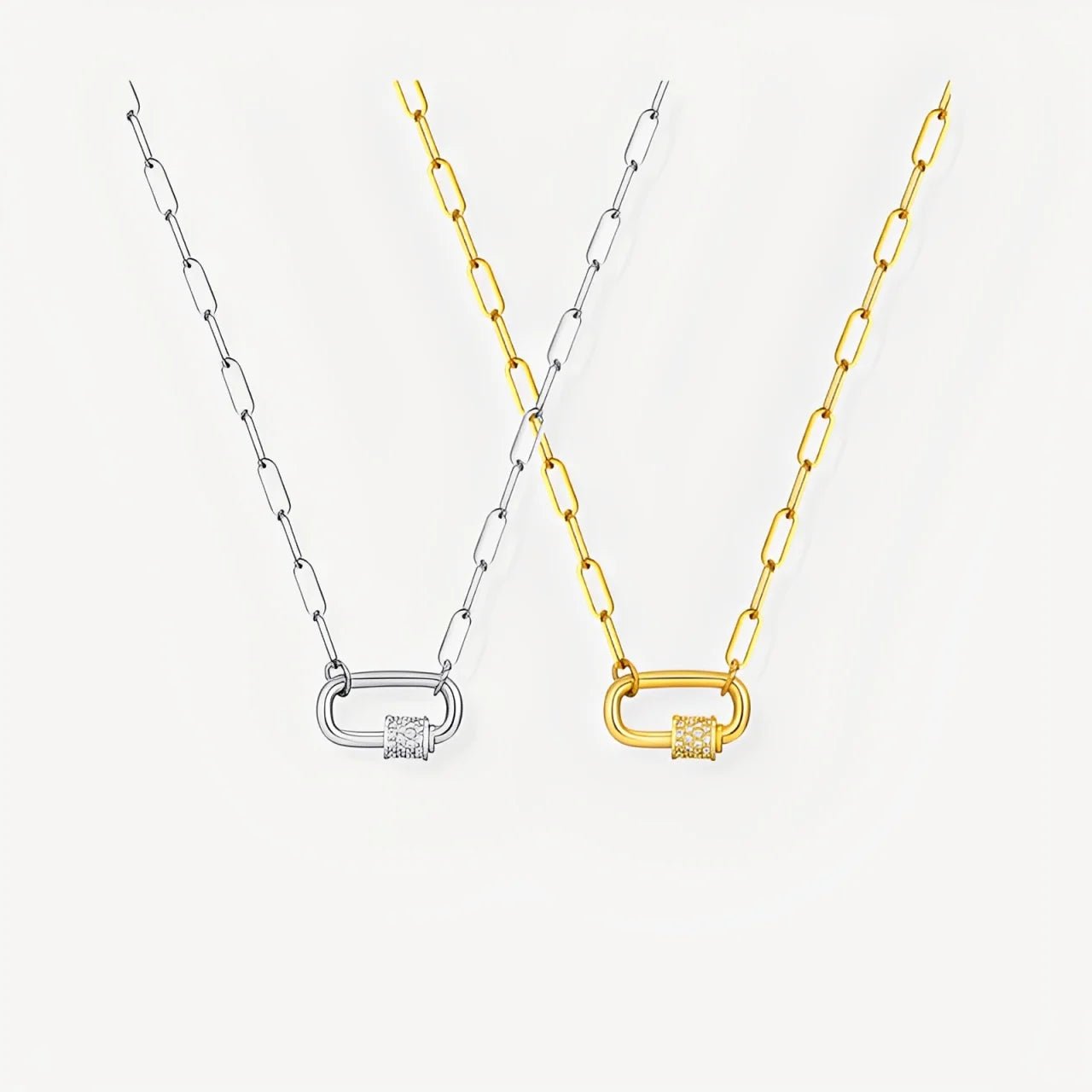 Two necklaces with lock pendants, one gold and one silver, on a light gray background.