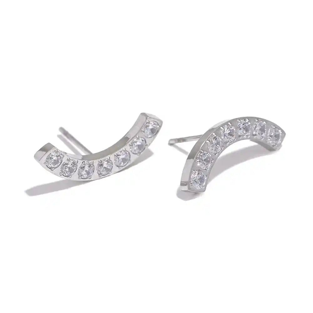 Pair of silver earrings with clear gemstones on a white background