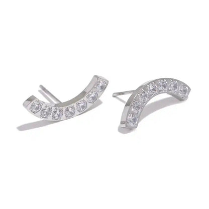 Pair of silver earrings with clear gemstones on a white background