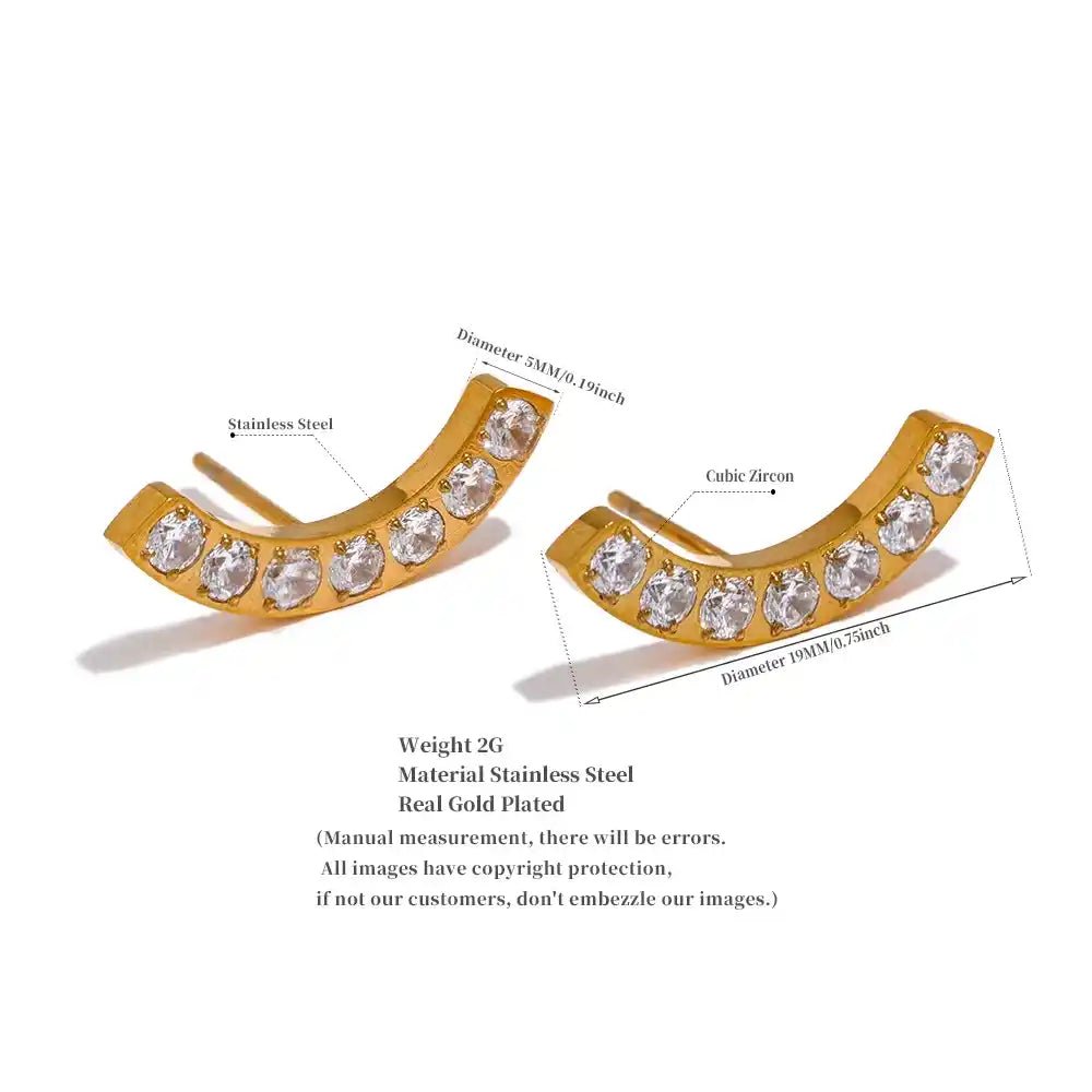 Gold earrings with clear stones on a white background
