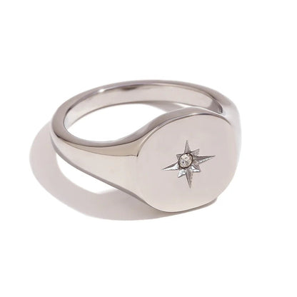 Silver ring with star design on a white background