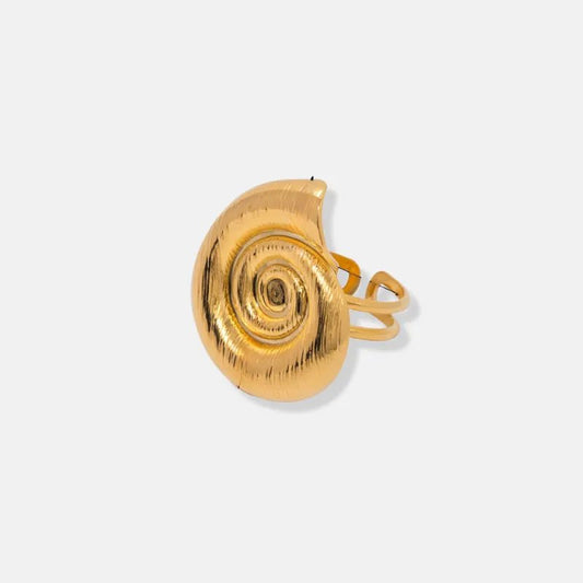 Gold snail-shaped earring on a light gray background