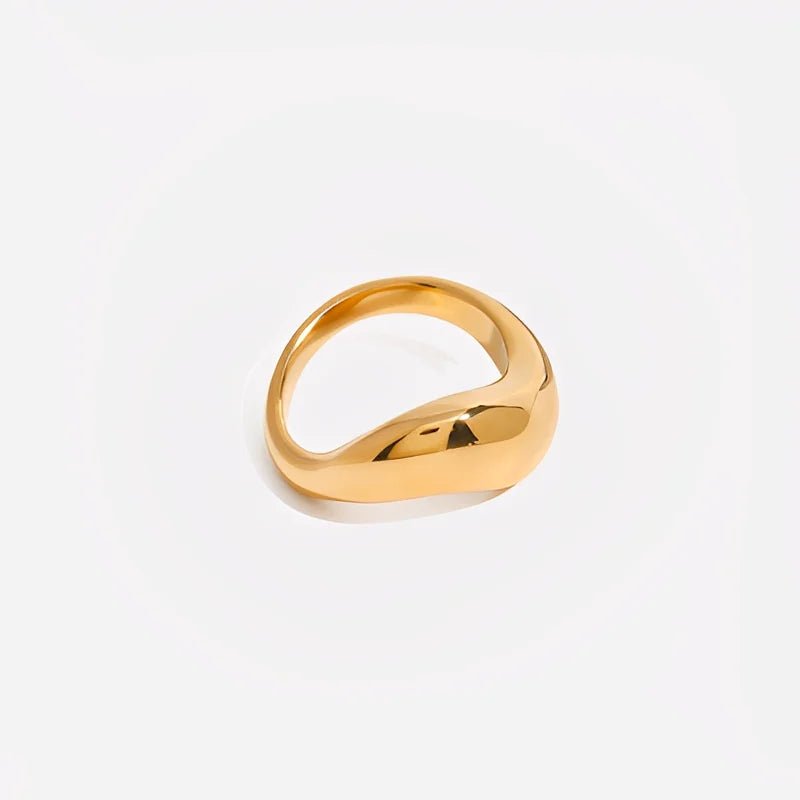 Gold ring on a light gray background