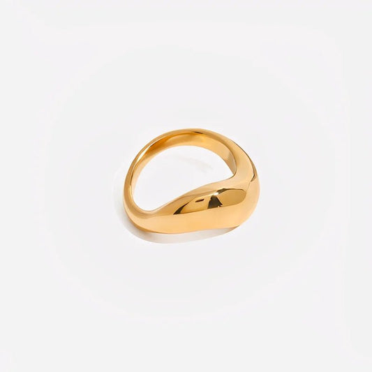 Gold ring on a light gray background