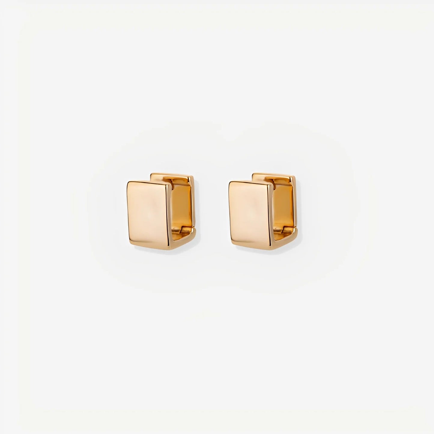 Gold square stud earrings on a white background
