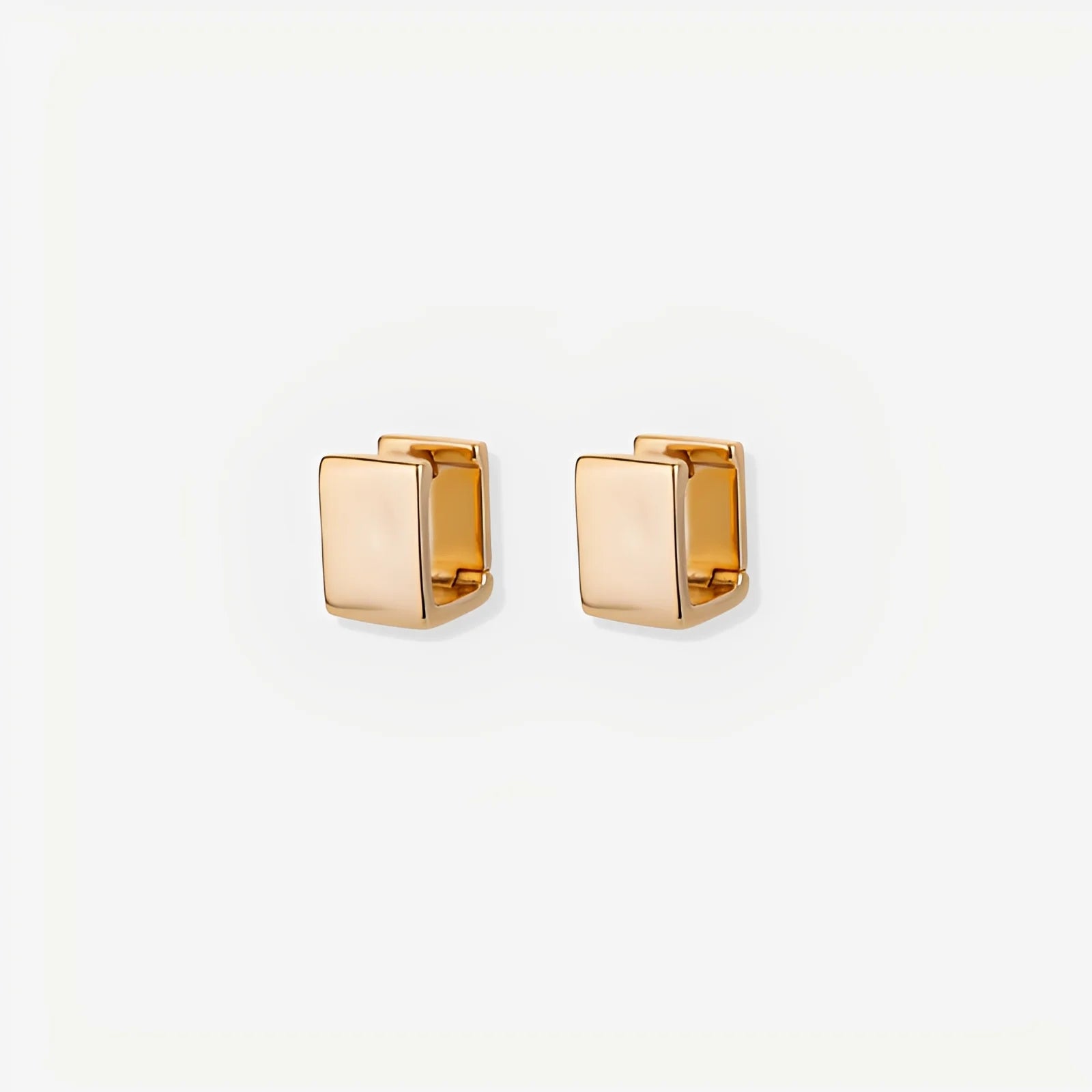 Gold square stud earrings on a white background